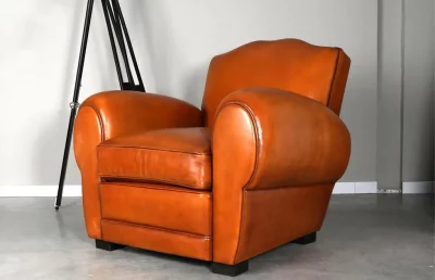 Grand Mustache leather club chair with a mustache-shaped backrest and curved armrests