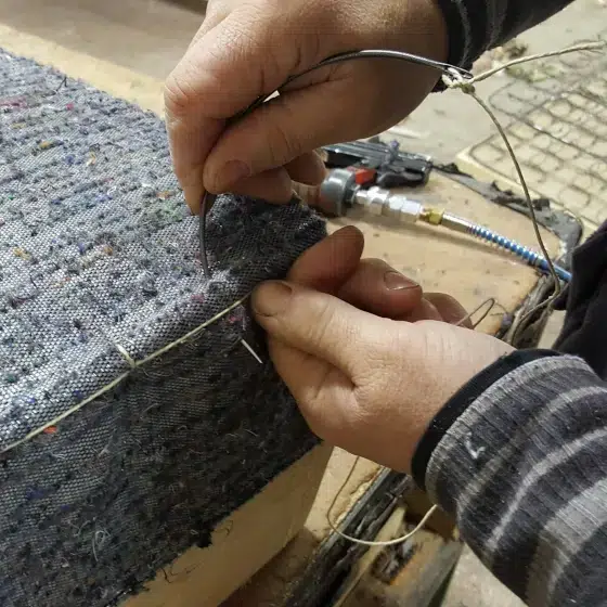 Step of the manufacturing process of a club chair, the stitching